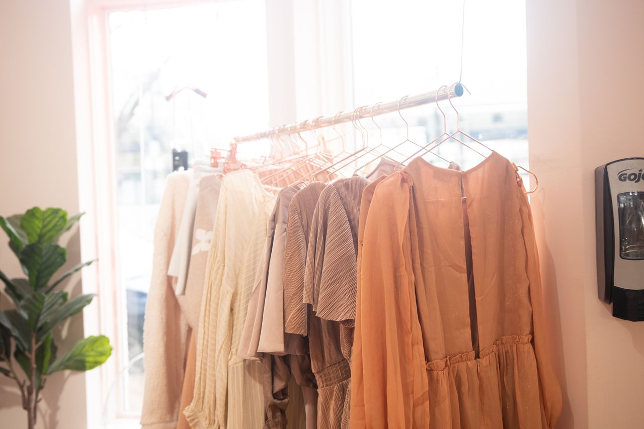 Mastering the First Impression: Your intriguing post title goes here A collection of stylish dresses on hangers in a bright boutique setting.